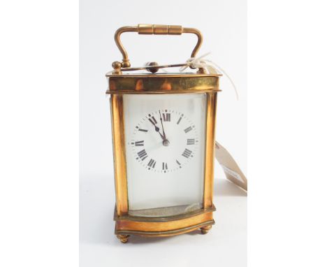 Small French brass carriage clock with key and convex glazed panel - 14cm high with handle up   Condition - small chip to gla