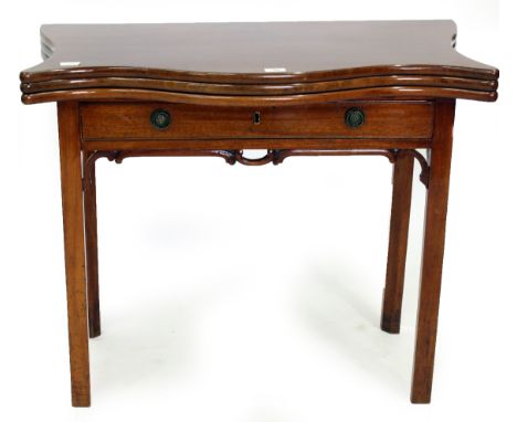 AN EARLY TO MID 18TH CENTURY MAHOGANY FOLD OVER TOP CARD TABLE with green baize lining, fitted with frieze drawer and standin