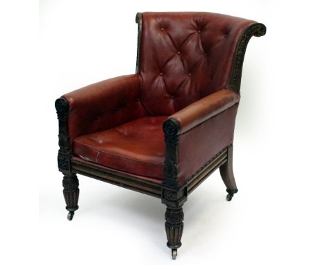 A REGENCY MAHOGANY FRAMED ARMCHAIR with husk tail decoration and button red leather upholstery, standing on fluted legs termi