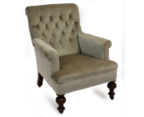 A LATE VICTORIAN UPHOLSTERED ARMCHAIR with turned supports and brass and ceramic castors 65cm wide x 81cm deep x 86cm high 