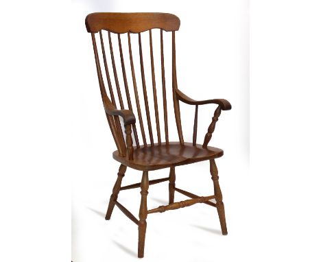 A LIGHT OAK SPINDLE BACK WINDSOR ARMCHAIR 61cm wide at the arms x 118cm high