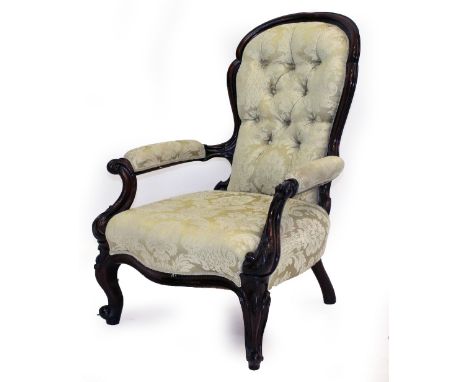 A VICTORIAN MAHOGANY FRAMED OPEN ARMCHAIR with button back upholstery and carved decoration, standing on cabriole legs, 96cm 