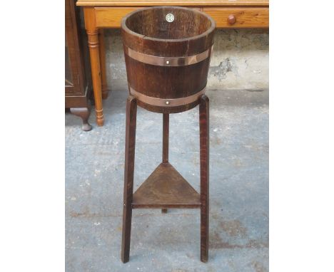 OAK COPPER BOUND BARREL FORM PLANT STAND ON TRI-SUPPORTS WITH MAKER'S LABEL RA LISTER &amp; CO LTD, DURSLEY