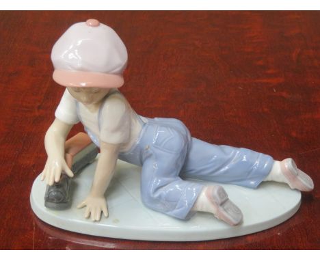 LLADRO COLLECTORS SOCIETY GLAZED CERAMIC FIGURE OF A YOUNG BOY PLAYING WITH A MODEL TRAIN, No 7619