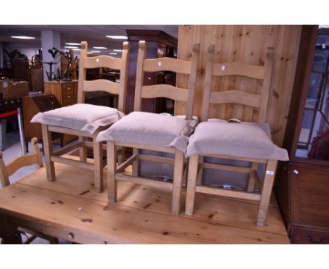 A natural pine kitchen dining table and set of four similar ladder back dining chairs, table approx. 183 x 91cm