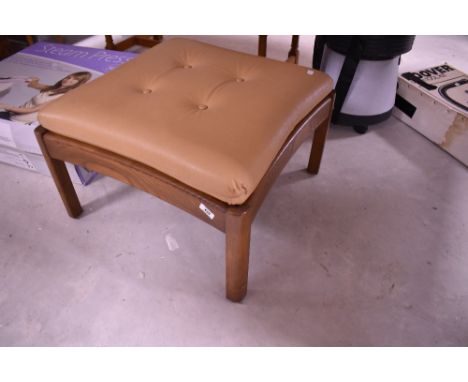An Ercol footstool with beige leather upholstery