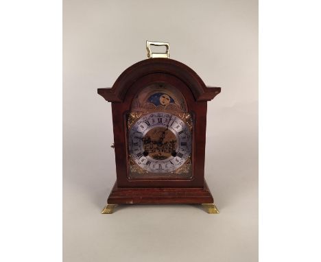 A 20th Century Dutch 18th Century style bracket clock with arch dial and moon face on ogee brass feet