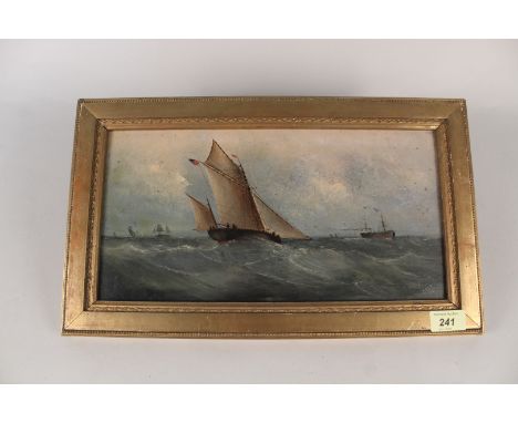 A late 19th Century oil on board of a seascape with shipping, signed 'C Beaty', 19cm x 57cm