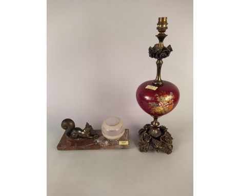 A 1930's table lamp with a metalware squirrel clutching a nut beside a small spherical shade mounted on a rose marble base pl