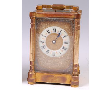 A circa 1900 French lacquered brass carriage clock, the case having proud three-quarter turned columns flanking engraved bras