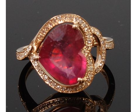 A contemporary 14ct yellow gold dress ring, set with heart cut spinel weighing approx 4.25ct, in a surround of pavé set small