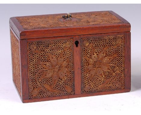 A George III mahogany and scrollwork tea caddy, of rectangular form, the panels worked as stylised flowers with traces of gil