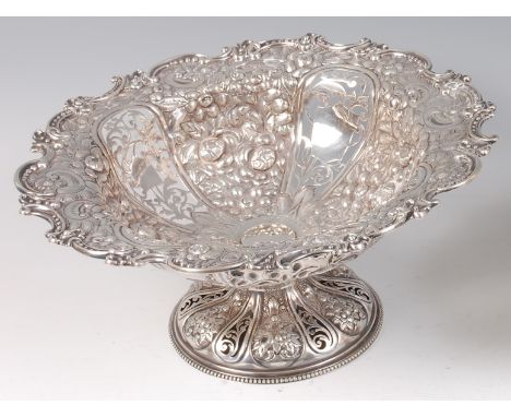 A late Victorian silver pedestal fruit bowl, having four pierced panels with all-over leaf, flower and C-scroll chased surrou