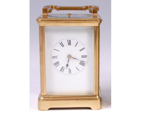 A circa 1900 French lacquered brass carriage clock, having visible platform escapement, push button repeat over a white ename
