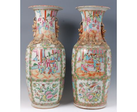 A pair of 19th century Chinese Canton floor vases, decorated in bright enamels with reserves of ceremonial figure scenes, ins