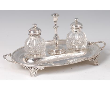 A Victorian silver inkstand, of beaded oval form, with bright cut engraved decoration, twin cut glass inkwells flanking centr