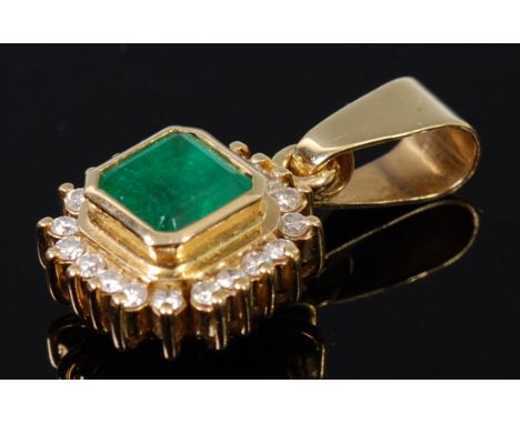 A modern 18ct gold emerald and diamond set pendant, the square cut emerald in a surround of small brilliants and on pendant b