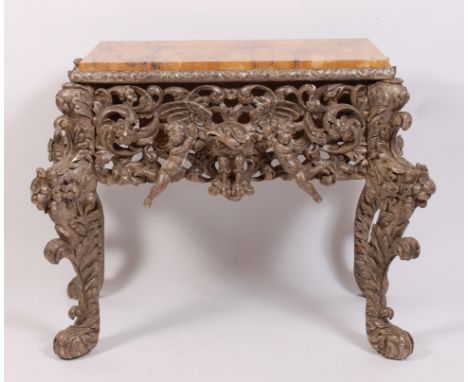 A late 18th century carved silvered wood console table, having a marble top, the frieze as two cherubs flanking a bird of pre