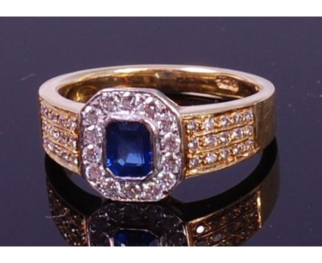 An Art Deco style 18ct gold, sapphire and diamond dress ring, the centre octagon cut sapphire in a surround of pavé set brill