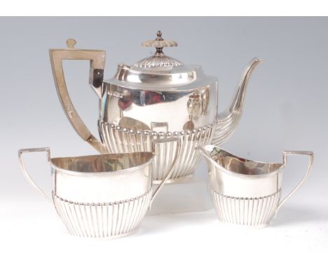 A Walker & Hall silver three piece teaset, comprising; teapot, twin handled sugar, and cream, each of half-reeded tapering ov