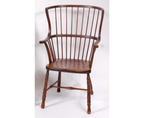 A circa 1900 stained beech comb-back farmhouse elbow chair, with dish seat