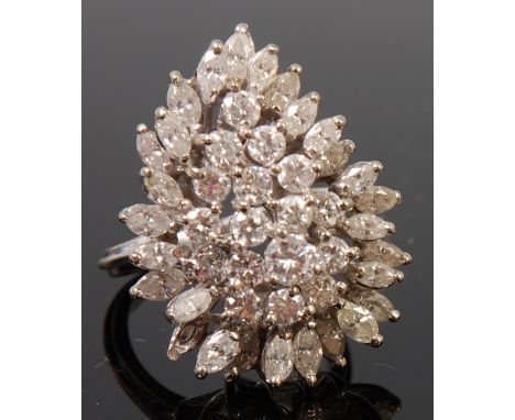 A 14ct white gold and diamond cocktail ring, arranged as seventeen tiered claw set brilliants, the largest weighing approx 0.