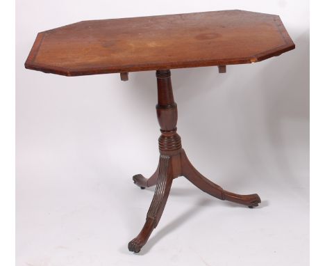 A Regency mahogany, crossbanded and herringbone strung table, the octagonal tilt-top on ring turned column to tripod base wit