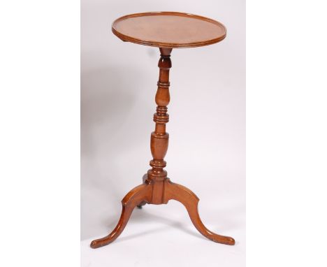 An early 19th century fruitwood and elm pedestal tripod table, having a dished two-piece top on ring turned urn column, dia. 