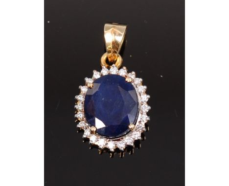 A modern 14ct gold, kashmir sapphire and diamond set pendant, the four claw set oval cut sapphire measuring approx 13 x 11 x 