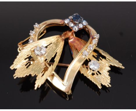 A modern 18ct gold, sapphire and diamond set brooch, arranged as a heart with a centre flower head issuing two leaves, each l