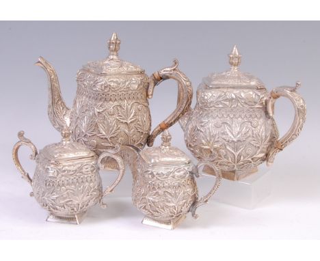 An Indian silver four piece tea service, comprising teapot, hot water pot, twin handled sugar and cover, and cream jug, each 