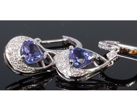A pair of contemporary 14ct gold, tanzanite and diamond set ear clips, the three claw set pear cut tanzanite in a surround of