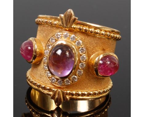 An Indian yellow metal, amethyst and diamond set heavy dress ring, having three cabochon amethysts, the centre within a surro