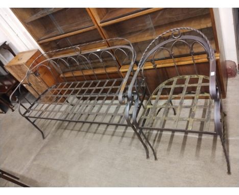 A wrought steel garden bench and matching chair 