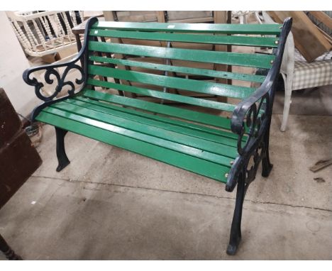 A cast iron and painted wooden garden bench 