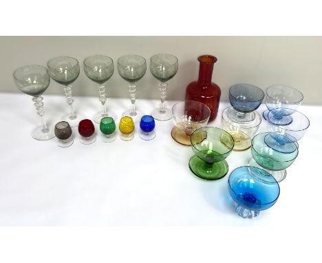 A selection of coloured glassware, including a ruby glass mallet decanter, goblets and a set of coloured glass bowls (a lot)