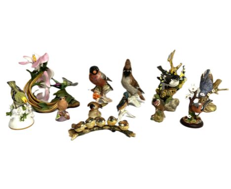 A collection of assorted figurines of birds, including a Goebel porcelain Bullfinch; a Boehm Hummingbird; also nuthatch, chaf