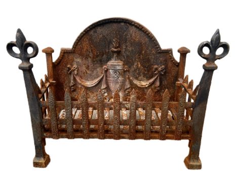 A vintage cast iron fire grate, with integral Adam style arched fire-back and fleur de lys finials