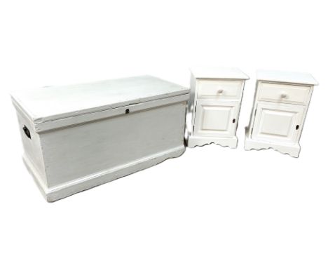 A blanket chest, painted in light grey, 104cm wide; with two white painted bedside cabinets (3)