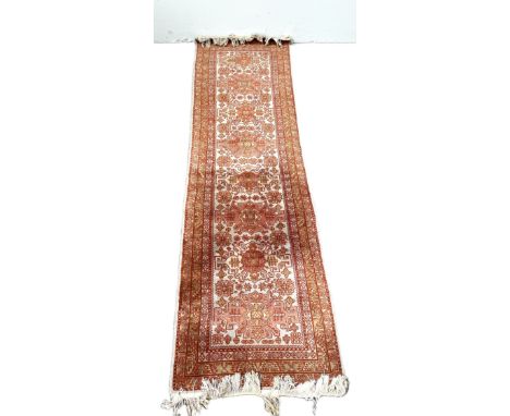 A modern Caucasian style runner, decorated with medallions on a light grey ground, 220cm long