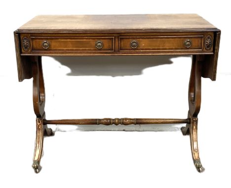 A Regency style mahogany veneer sofa table, with drop leaf top and Lyre end supports, 74cm high, 103cm wide