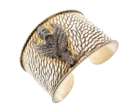 Diamond and ruby silver bangle, the cast applied eagle and snake motif full set with small round eight cut diamonds and ruby 