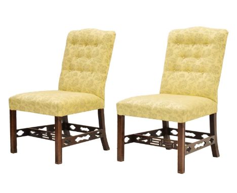 Pair of George III style mahogany framed drawing room chairs, in the Chippendale manner, the serpentine button-back overstuff