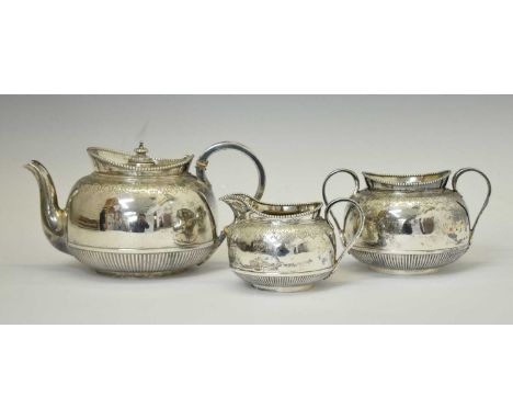 Victorian silver three-piece tea service comprising teapot, twin handled sugar bowl, and cream jug, each piece with half flut