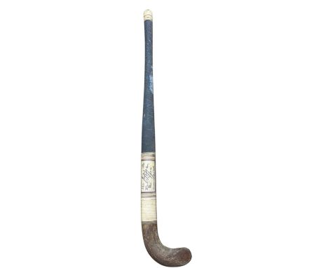 A vintage Bulldog field hockey stick, bearing the printed signatures of the 1938 Indian Olympic Hockey Team