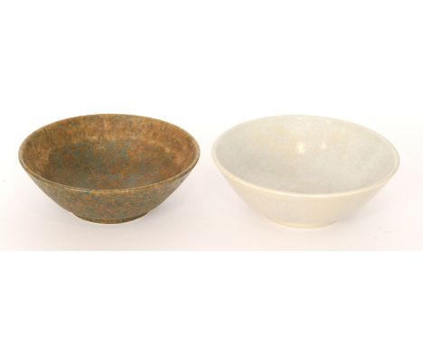 Two Ruskin Pottery high sided footed bowls, the first glazed in a pale blue and pale yellow, dated 1927, the second in dark b