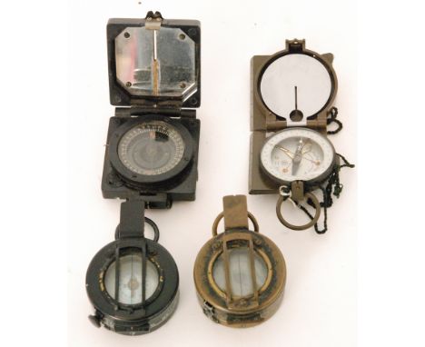 A black painted and a brass compass by T G.Co Ltd 1944, a magnetic marching MK1 compass and a similar Japanese compass in lea