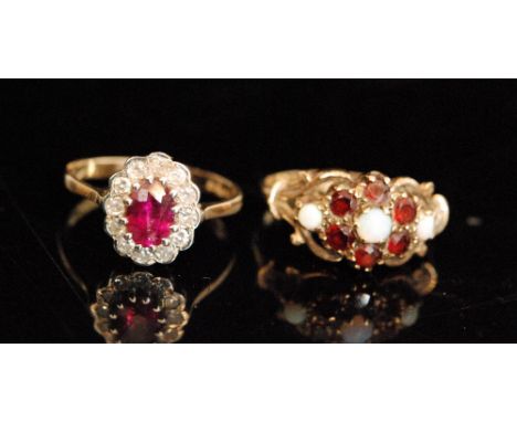 A 9ct ruby and diamond cluster ring, oval cut ruby within a diamond surround to knife edge shoulders and a garnet and opal cl