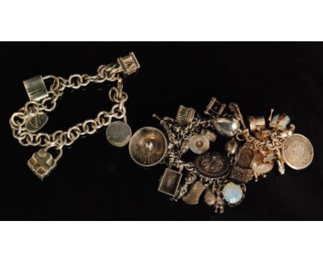 A Tiffany and Co, New York Sterling silver charm bracelet with five suspended charms to include a 'Please return to Tiffany &