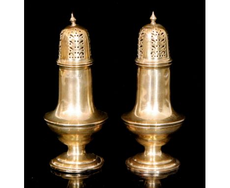A pair of hallmarked silver sugar sifters, each of plain baluster form with pull off pierced cover and baluster finial, Birmi